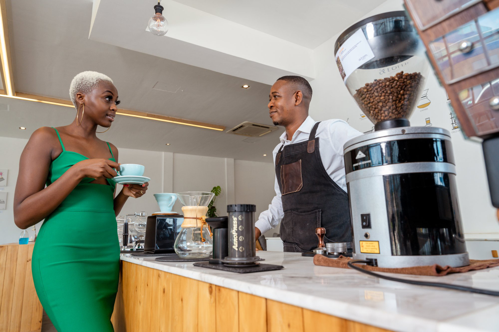 Guest and barista chatting across the Baraza brew bar