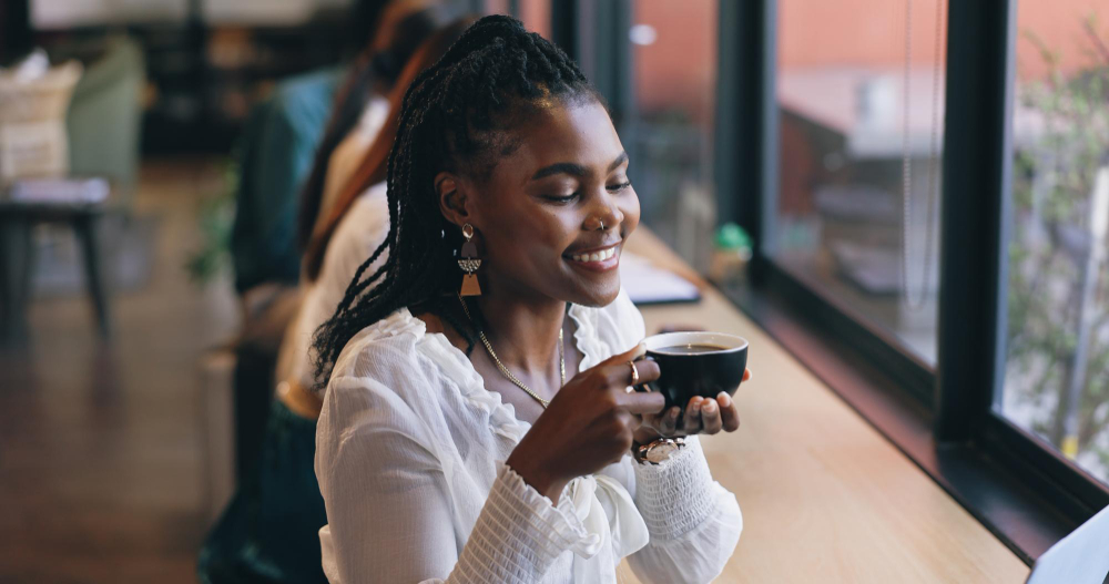 A guest enjoying coffee by the window at Baraza.