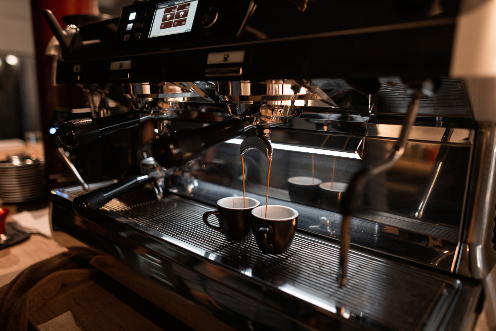 Double espresso pouring into two cups on the machine