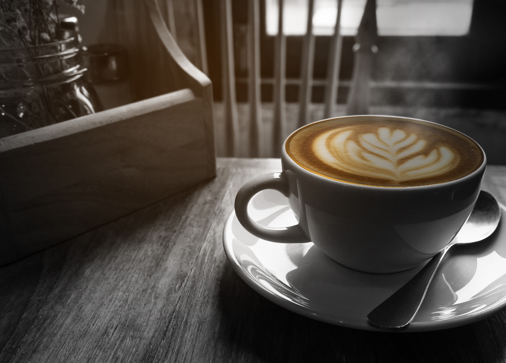 A cup of latte art in warm light.